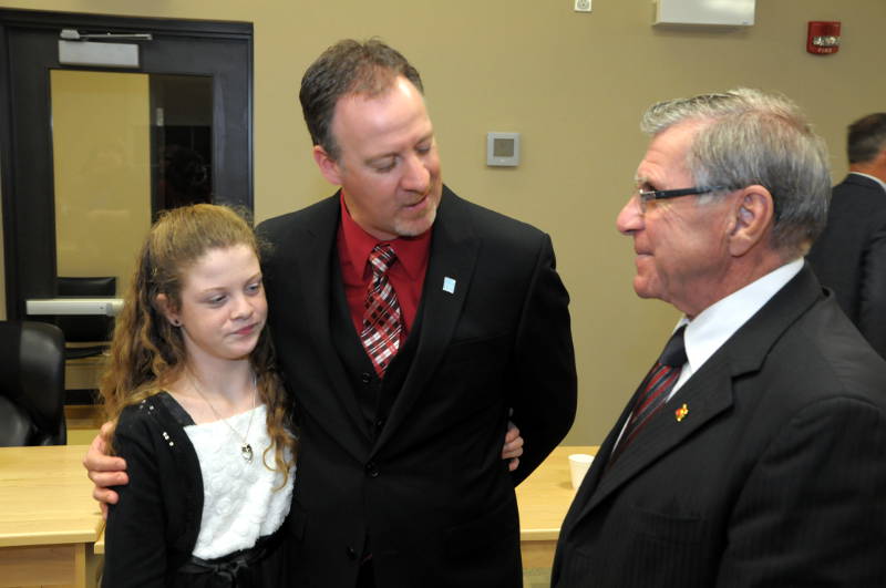 Councillor Marc St. Pierre with his daughter Victoria, 12, talk with MP Guy Lauzon, right. St. Pierre and the rest of South Dundas municipal council were sworn in Dec. 2, 2014. (Cornwall Newswatch/Bill Kingston)