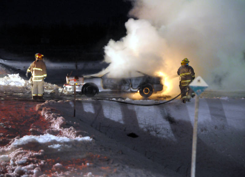 Firefighters battle a car fire on Jan. 5, 2015, about three kilometers north of St. Andrews West on Highway 138. The owner had been having car trouble prior to the fire, according to the assistant deputy fire chief. (Cornwall Newswatch/Bill Kingston)