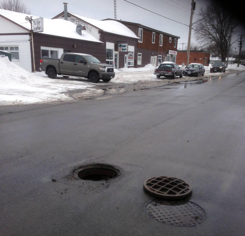 A manhole cover lies on Fifth Street in Morrisburg on Mar. 4, 2015. A witness says at least two cars hit the obstruction. (Photo/Submitted)