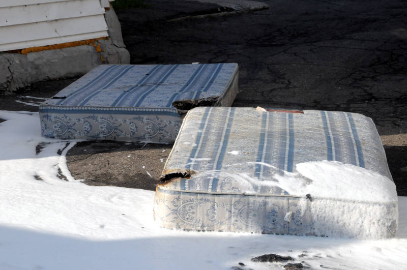The mattress and box spring lay in the driveway of a Prince Arthur Street home after a fire on May 28, 2015. The homeowner was treated by paramedics for smoke inhalation. The fire department says the cause was careless smoking. (Cornwall Newswatch/Bill Kingston)