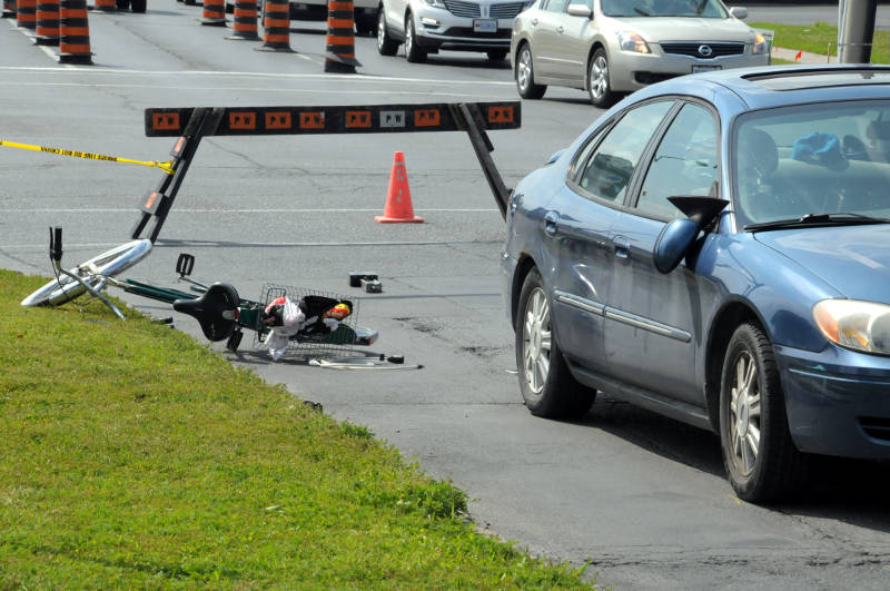 Looking south on Sydney Street, a bicycle lays on the grass after a collision with this sedan just north of the intersection at Ninth Street on July 14, 2015. (Cornwall Newswatch/Bill Kingston)