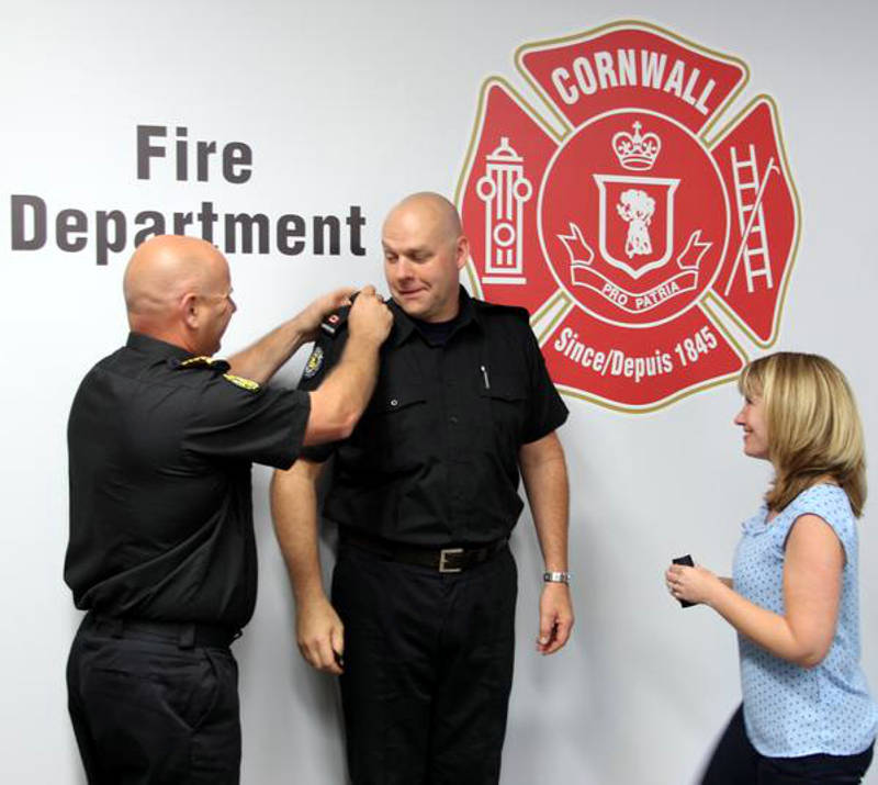 Fire Chief Pierre Voisine, left, places the rank insignia on Bruce Donig, who has been appointed deputy fire chief effective July 2, 2015. (Photo/City of Cornwall)