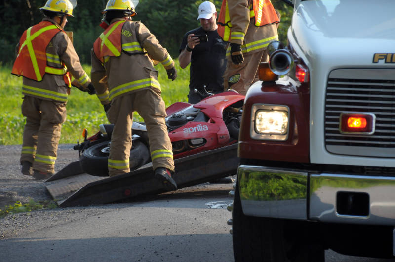 South Glengarry firefighters recover a sportbike from a deep ditch on South Service Road on July 5, 2015 after a single vehicle crash. The rider was taken to hospital with non-life threatening injuries. (Cornwall Newswatch/Bill Kingston)