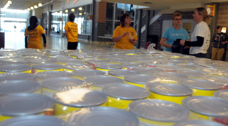 Members of the Interact clubs at St. Lawrence high school and CCVS speak with Agape Center Executive Director Alyssa Blais, right, during the Canstruction competition Friday, April 15, 2016. The two high school clubs are building a large Spiderman figure out of cans of salmon. (Newswatch Group/Bill Kingston)