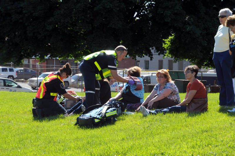 Paramedics with the Cornwall/SD&G Paramedic Service treat several workers on the lawn near the Agape Center Wednesday, June 15, 2016 after some where overcome by a noxious smell in the air inside the building on Sixth Street. Some were taken to hospital as a precaution. (Newswatch Group/Bill Kingston)