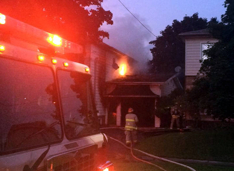 In this Wednesday, Aug. 31, 2016 photo supplied by Keelan O'Flaherty, flames leap from a section of the roof next to the garage of this two storey home on Gardner Avenue. (Keelan O'Flaherty via Newswatch Group)