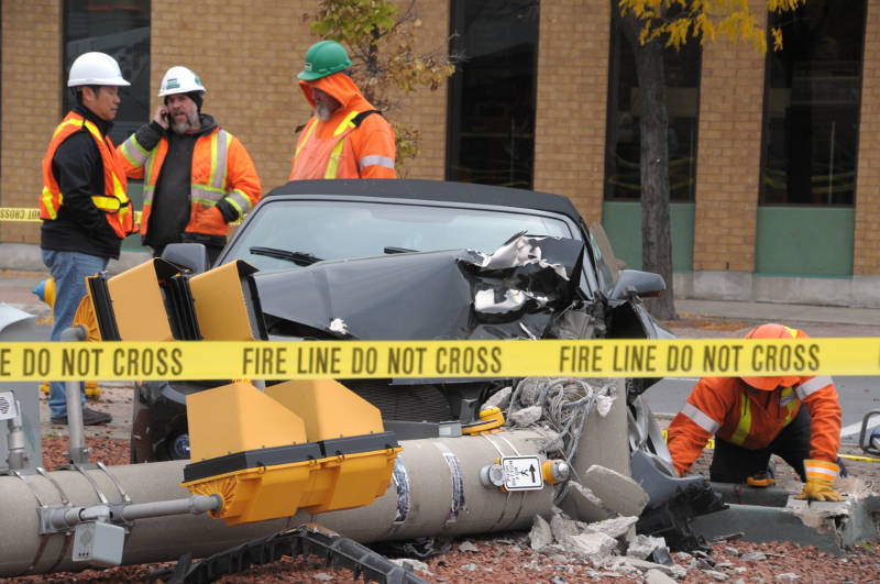 The remains of a Chevrolet Camaro sit beside a sheared off light standard at the intersection of Ninth and Pitt Streets in Cornwall, Ont. on Wednesday, Oct. 26, 2016. Police say no one was hurt. (Newswatch Group/Bill Kingston)