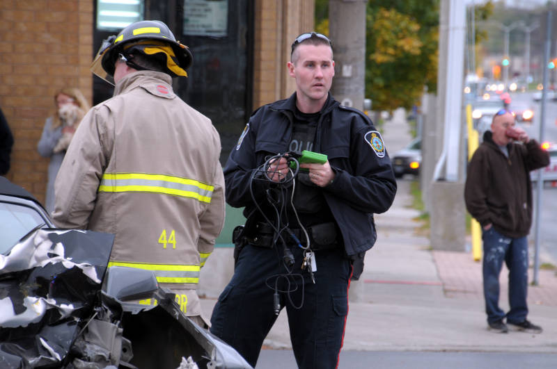 Cornwall Community Police Service Const. Matt Dupuis finishes uploading the data from the on board computer in a Chevrolet Camaro, involved in a two vehicle crash. The collision on Wednesday, Oct. 26, 2016 destroyed the Camaro and a Toyota Matrix but everyone walked away unhurt. (Newswatch Group/Bill Kingston)